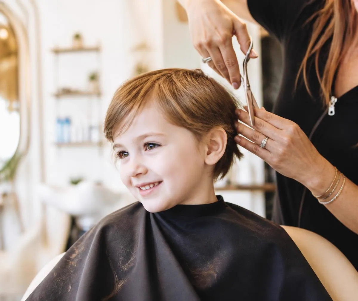 A child having a gentle scissor cut at Kidstyles Salon
